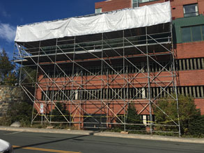 Scaffolding and tarps installed at Quality Hotel.
